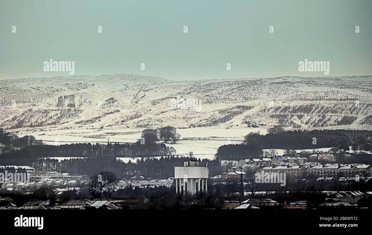 Glasgow, Scotland, UK, 12th March, 2020: UK Weather: Overnight snow was highlighted on the Kilpatrick hills in the north west of the city over the suburb of Drumchapel  and its famous water tower. Copywrite Gerard Ferry/ Alamy Live News Stock Photo