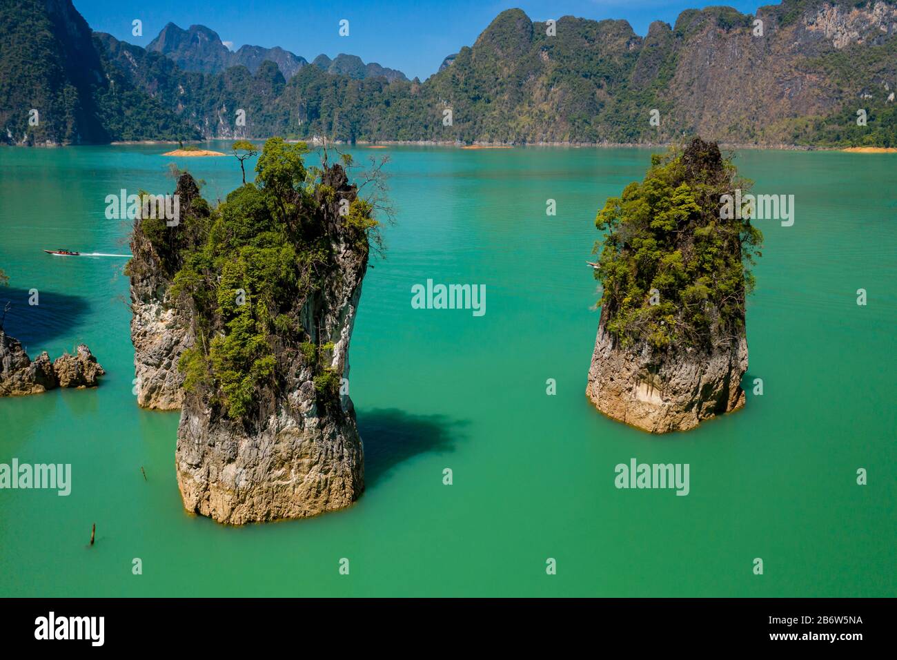 Low angle aerial view of spectacular limestone fingers of rock in a huge lake (The Guilin of Thailand, Cheow Lan Lake) Stock Photo