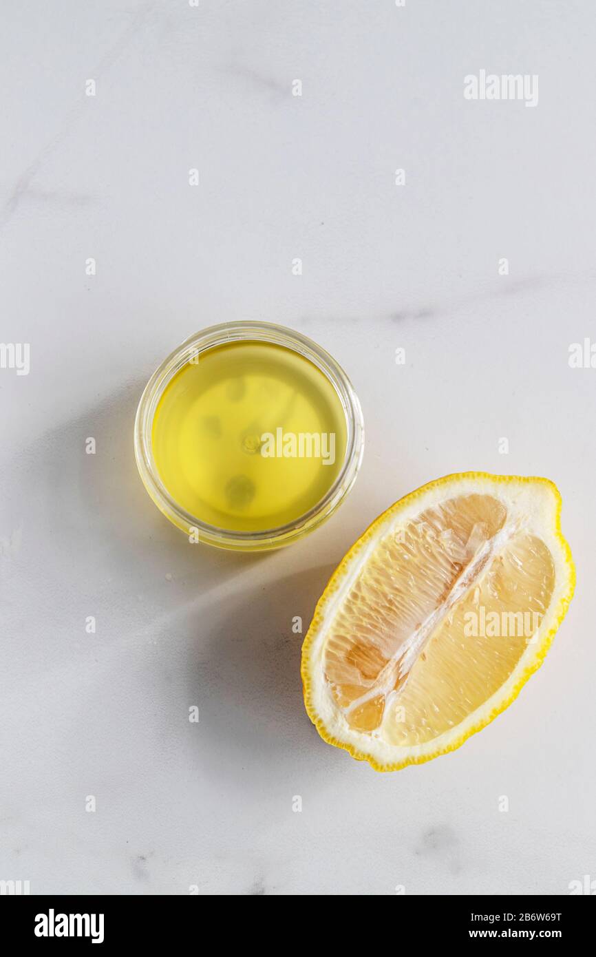 Cosmetic oil for body or face with lemon extract and citrus fruits on