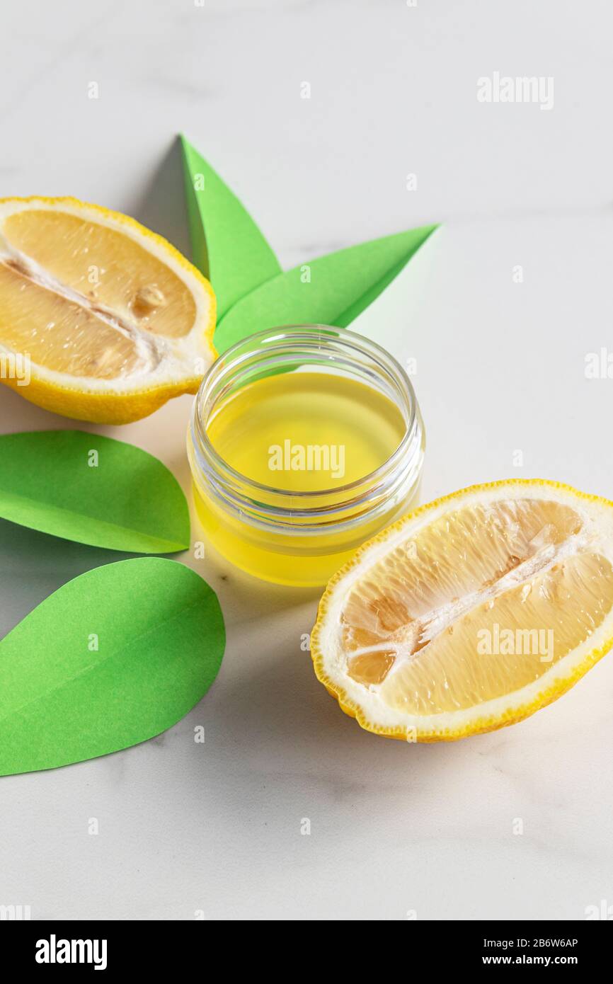 Cosmetic oil for body or face with lemon extract and citrus fruits on