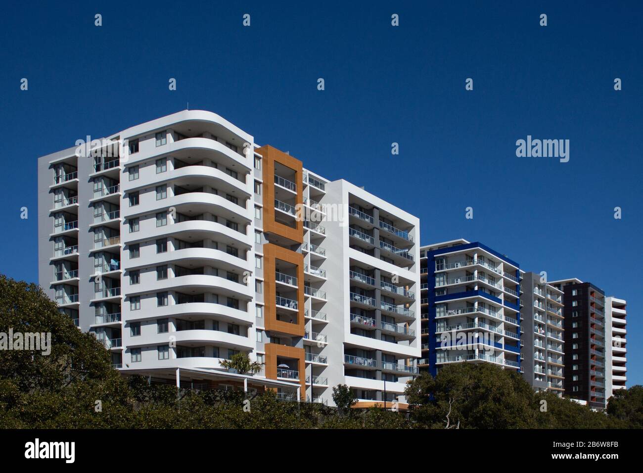 Urban high rise apartment condominiums community against blue sky Stock Photo