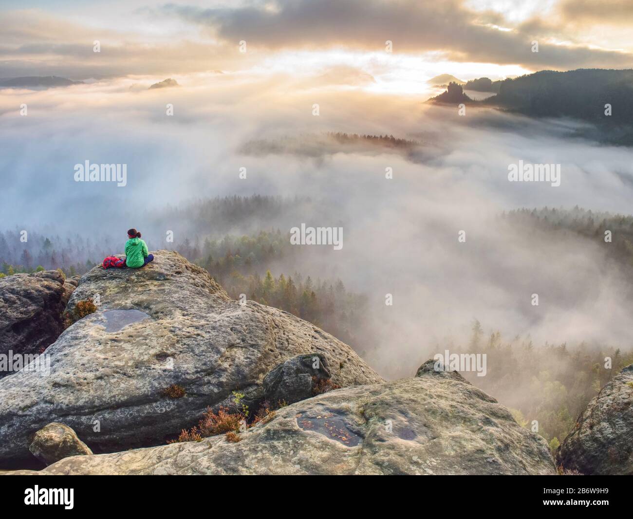 Woman with knitted hat sit in the nature reserve in Germany Stock Photo