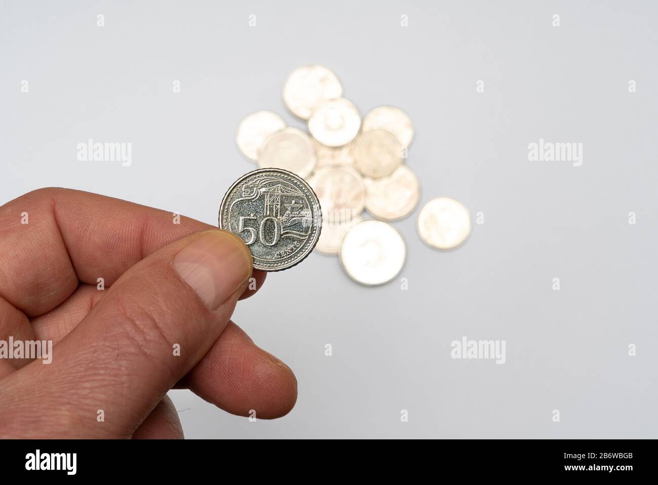 A 50 cents of Singaporean dollar coin on a white surface Stock Photo