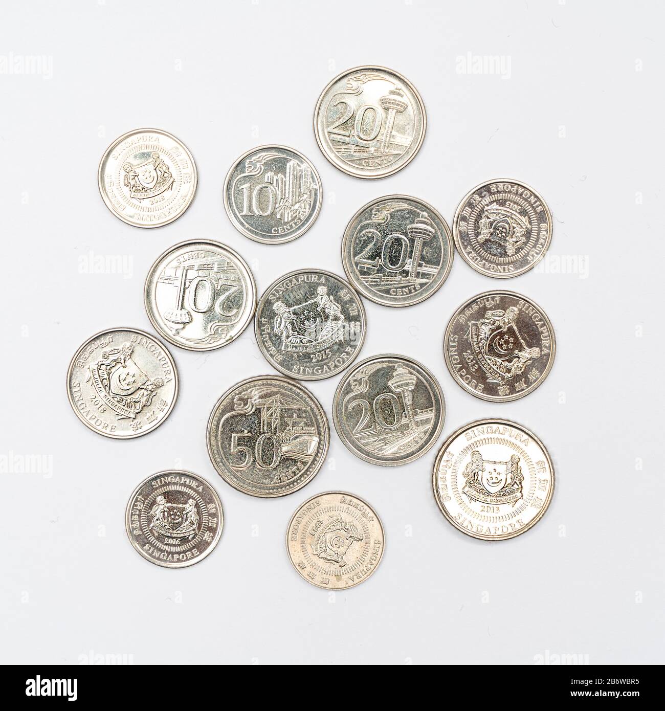 some Singaporean dollar coins on a white surface Stock Photo