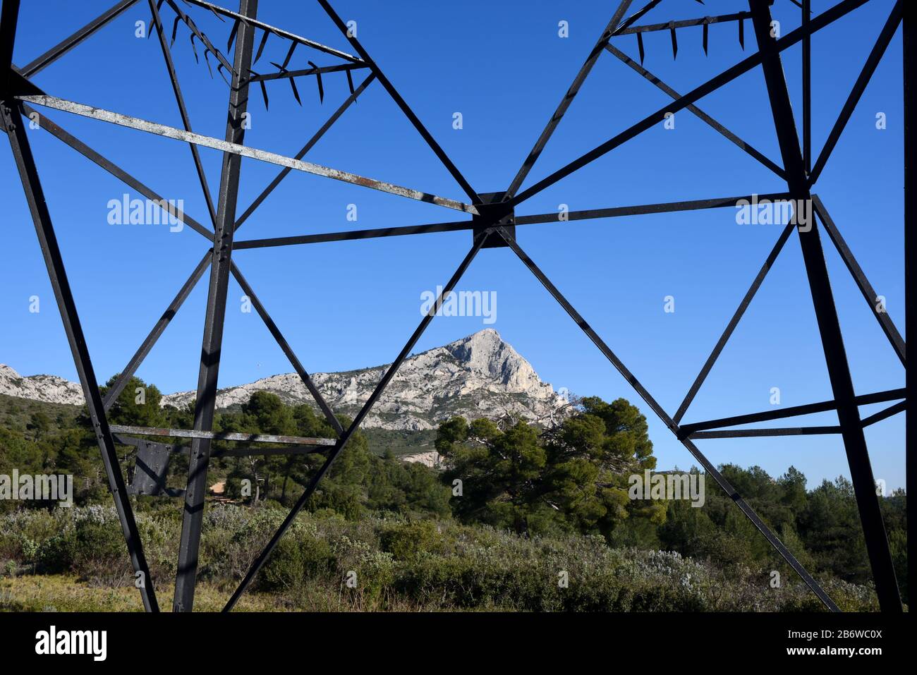 Mont Sainte-Victoire Mountain Framed by Steel Framework of  Electricity Pylon, Transmission Tower or Truss Tower near Aix-en-Provence Provence France Stock Photo