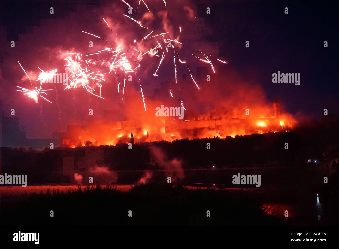 colorful fire works exploding above the old stone medieval castle of