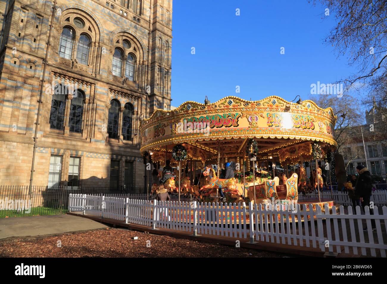 A carousel, as part of the Christmas holiday activities, outside the Natural History Museum in South Kensington, London, UK. Stock Photo