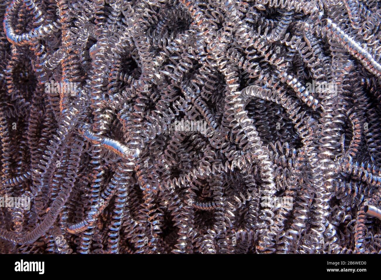 CNC metal waste, spirals of swarf background Stock Photo