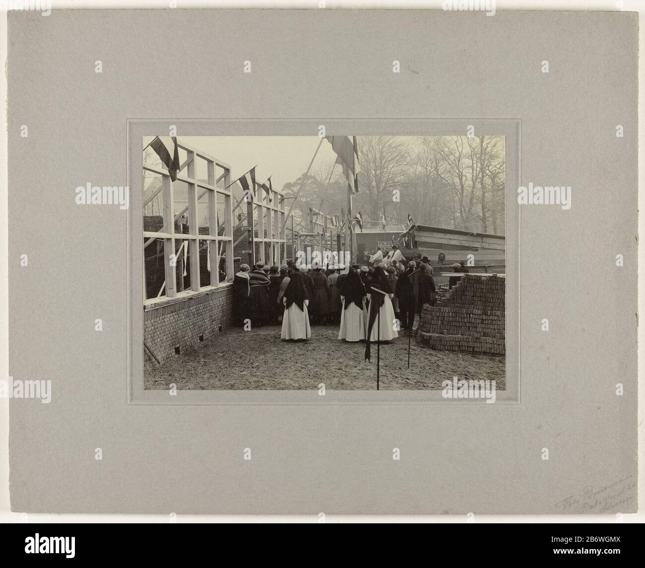 Inzegening lagere school At a school under construction Catholic clergy working bless the school. In the foreground, a few nuns, behind children. hung from the frames Dutch vlaggen. Manufacturer : Photographer: anonymous place manufacture: Netherlands Date: 1920 - 1930 Material: paper Technique: Photography Dimensions: carton design: h 24 cm. B × 30 cm. Subject When: 1945 - 1955 Stock Photo