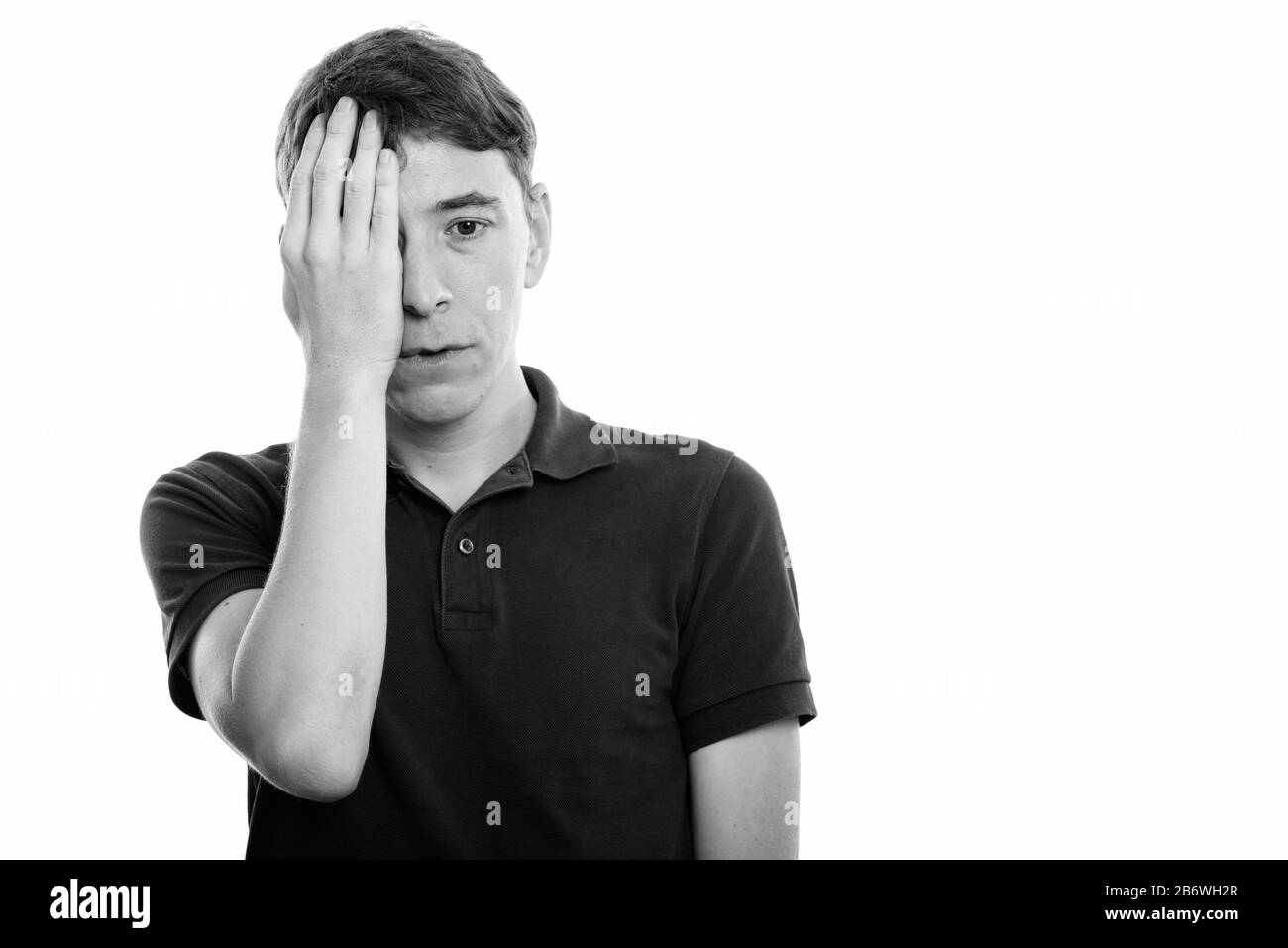 Studio shot of stressed man covering face with hand Stock Photo - Alamy