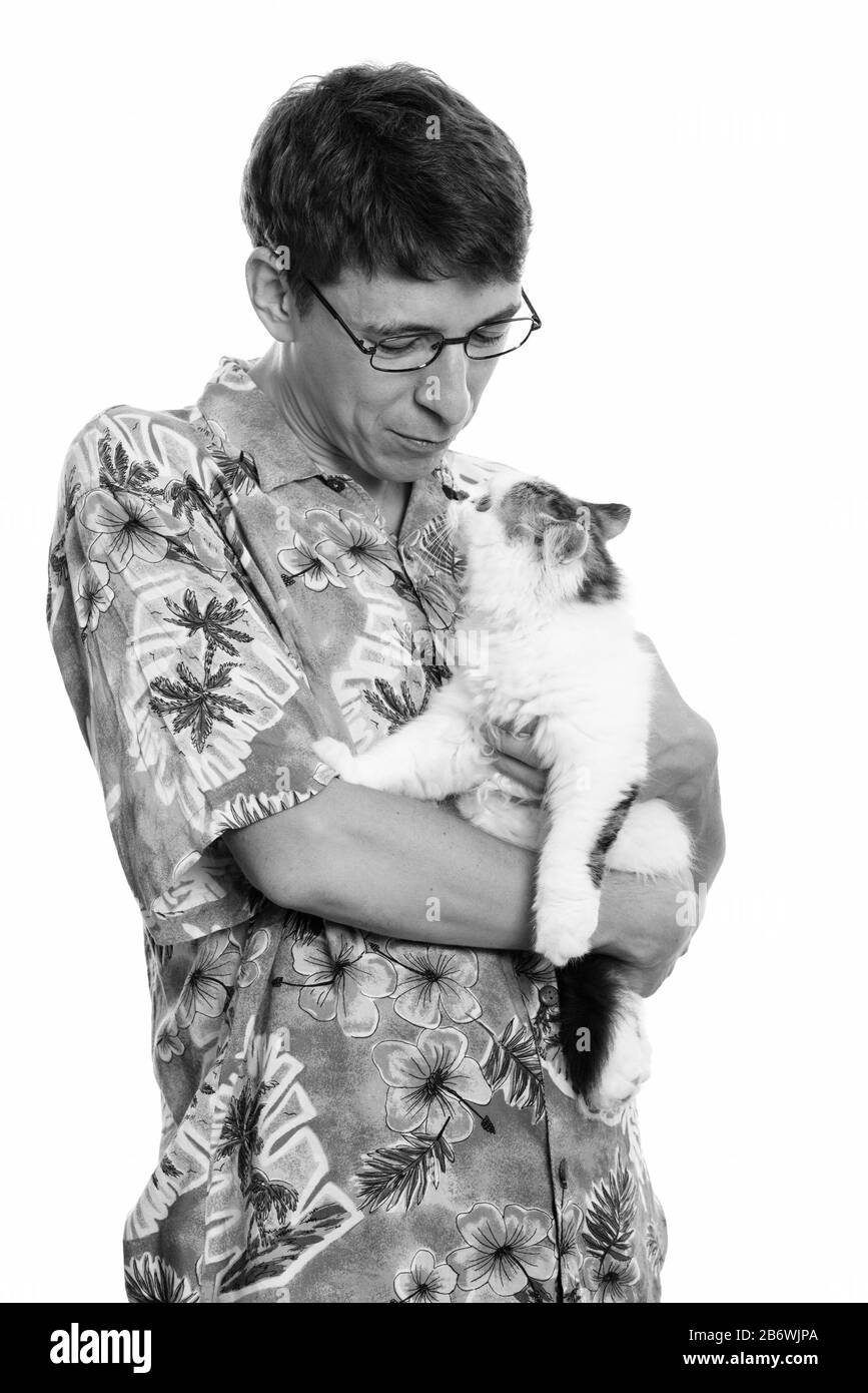 Studio shot of man holding and looking at cute cat Stock Photo