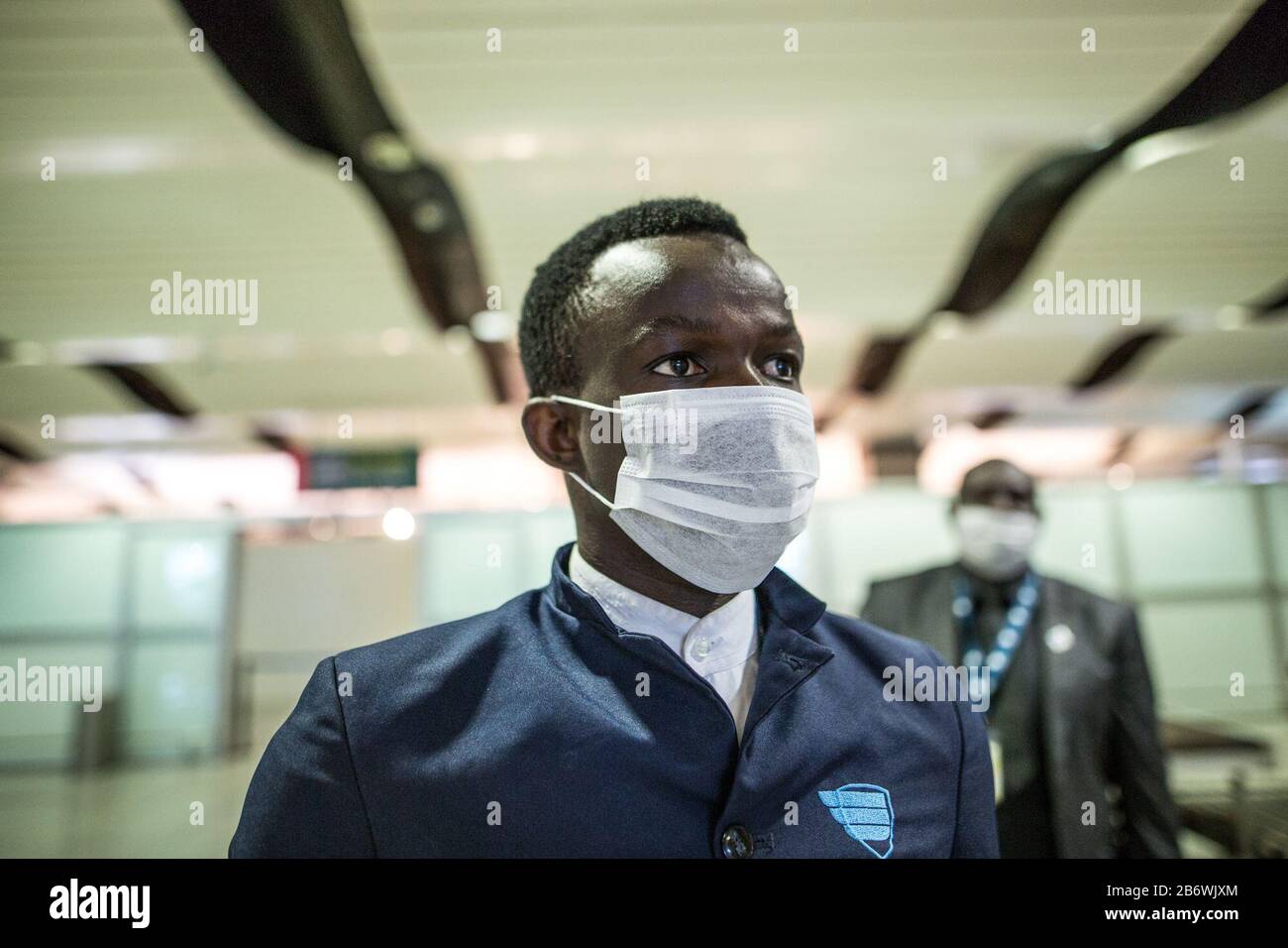 Dakar. 10th Mar, 2020. Photo taken on March 10, 2020 shows an airport employee wearing face mask in Dakar, Senegal. Senegalese Ministry of Health and Social Action confirmed the country's fifth case of the COVID-19 on Wednesday. In order to prevent more cases from entering Senegal, the authorities of Blaise Diagne International Airport, under the guideline of Senegalese Ministry of Health and Social Action, have intensified all the necessary measures to detect cases of the novel coronavirus. Credit: Eddy Peters/Xinhua/Alamy Live News Stock Photo