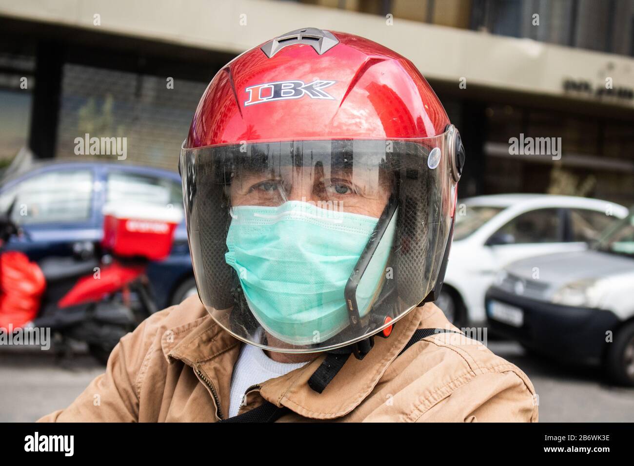 BEIRUT, LEBANON. 12 March 2020. A motorcycle rider  is seen wearing a protective face mask  against  the covid 19 novel coronavirus in Beirut. Lebanon has recorded its second death to the coronavirus virus with  68 confirmed cases in the country of some four million people. Credit: amer ghazzal/Alamy Live News Stock Photo