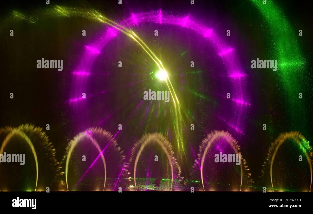 Colorful water fountains. Beautiful laser and fountains show. Large multi colored decorative