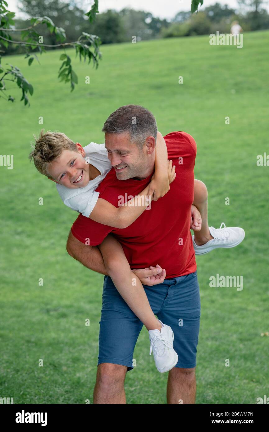 Father carrying his son hi-res stock photography and images - Alamy