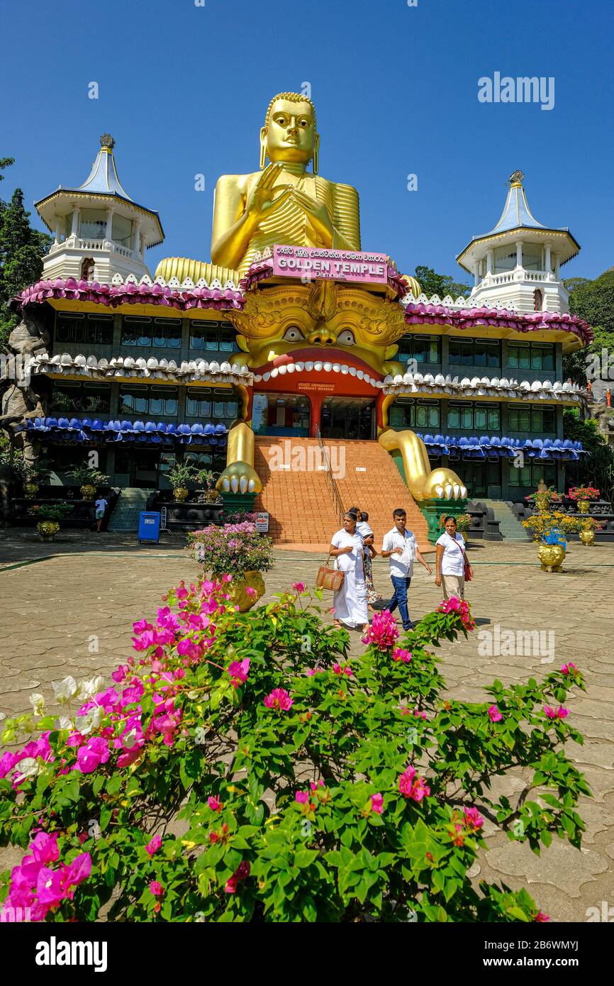 Dambulla, Sri Lanka - February 2020: People visiting Golden temple of Dambula on February 8, 2020 in Dambulla, Sri Lanka. Stock Photo