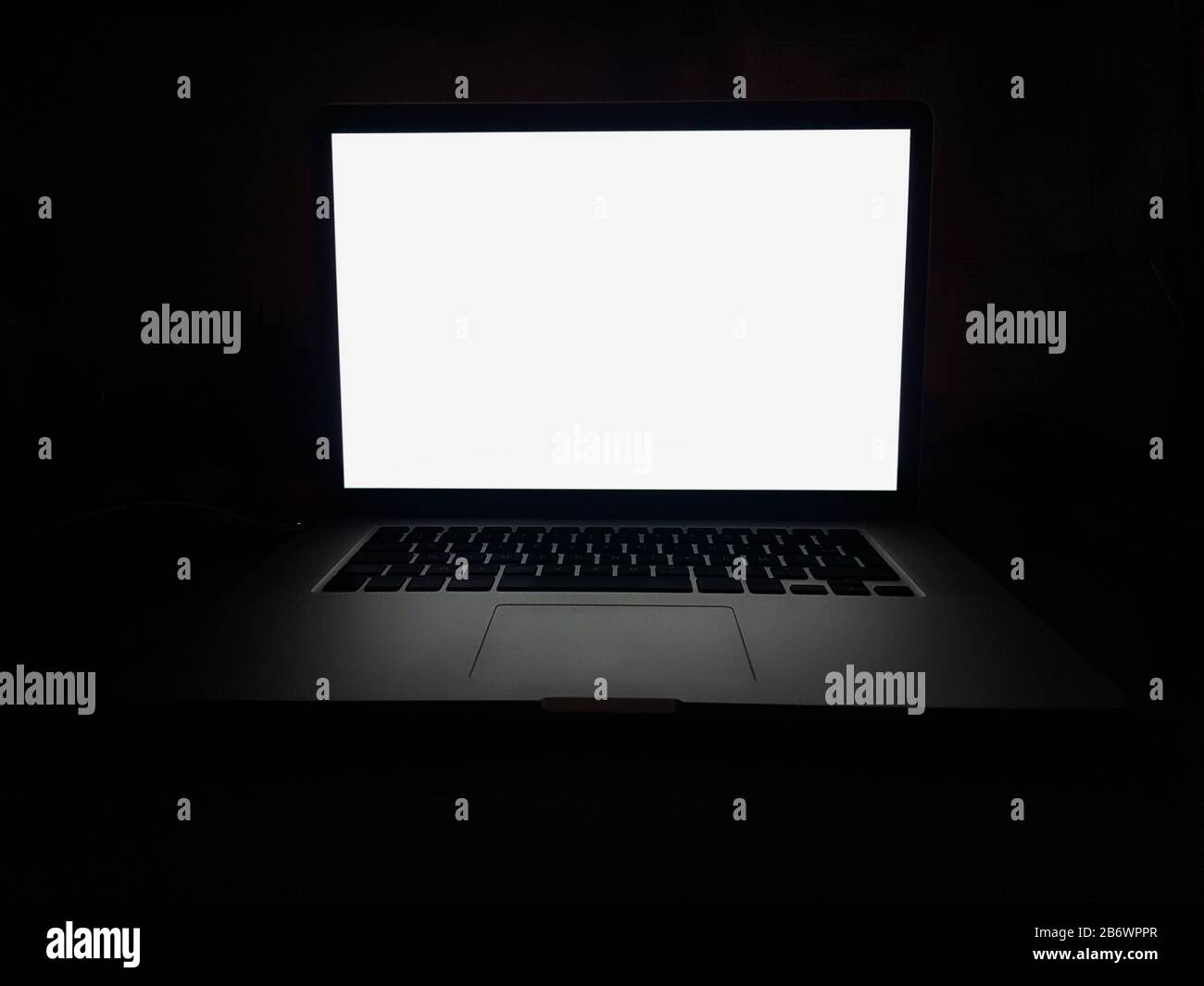 open laptop with blank screen on dark background Stock Photo