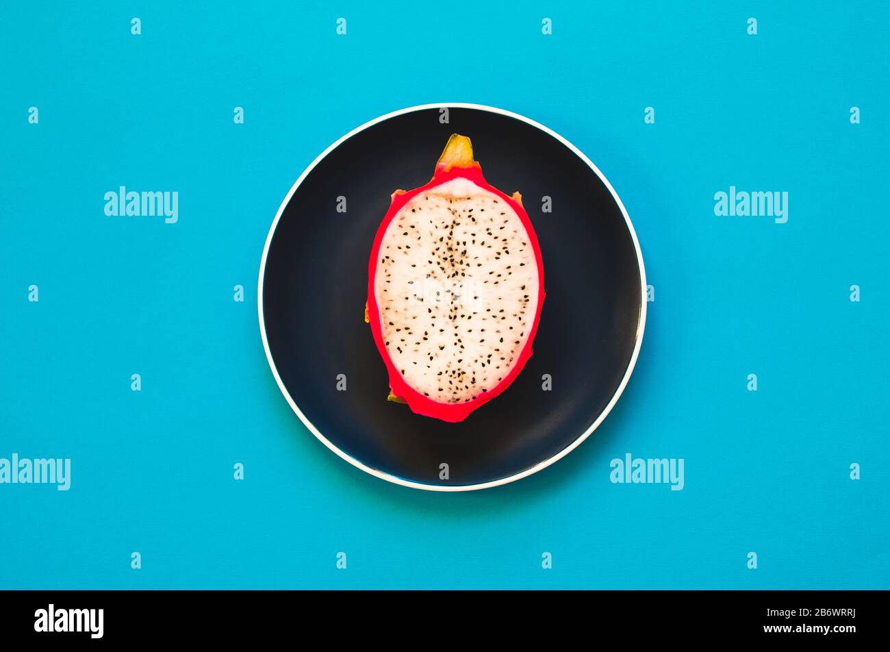Pitaya. The close-up of ripe dragon fruit on plate on yellow background. Stock Photo
