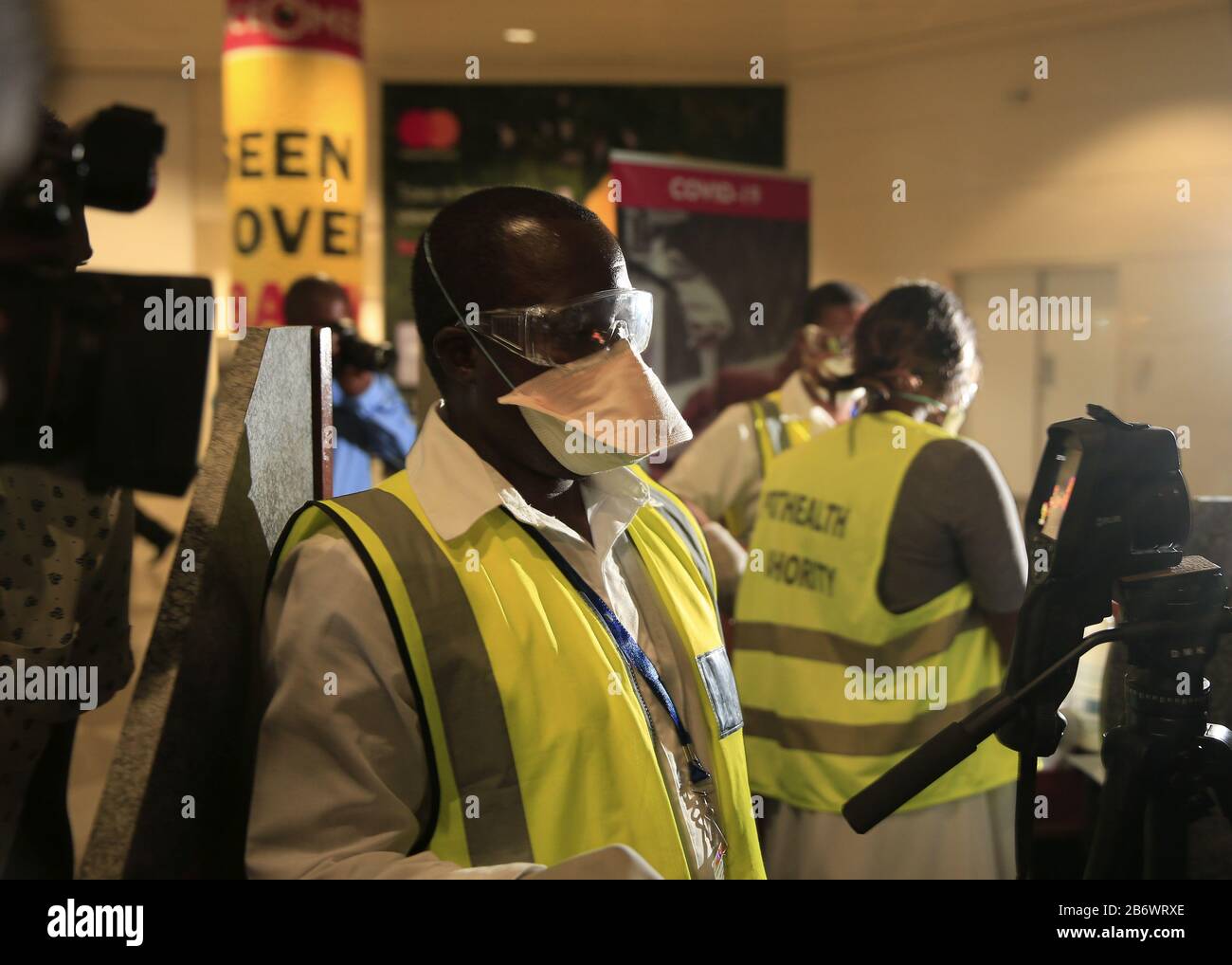 (200312) -- HARARE, March 12, 2020 (Xinhua) -- Staff wearing face masks work at the Robert Gabriel Mugabe International Airport in Harare, Zimbabwe, March 11, 2020. Zimbabwe's main airport is '60 percent prepared' to deal with COVID-19 and more resources are required for training and procurement of essential protective equipment for critical staff, Ruth Labode, chairperson of the parliamentary portfolio committee on health said Wednesday, after touring the Robert Gabriel Mugabe International Airport in Harare to assess its preparedness to deal with the virus. (Photo by Shaun Jusa/Xinhua) Stock Photo