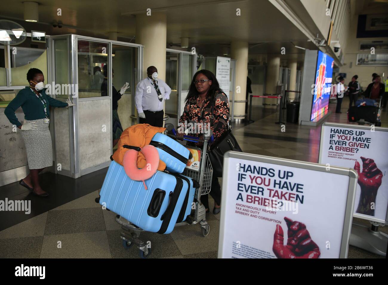 (200312) -- HARARE, March 12, 2020 (Xinhua) -- A passenger passes the customs check point at the Robert Gabriel Mugabe International Airport in Harare, Zimbabwe, March 11, 2020. Zimbabwe's main airport is '60 percent prepared' to deal with COVID-19 and more resources are required for training and procurement of essential protective equipment for critical staff, Ruth Labode, chairperson of the parliamentary portfolio committee on health said Wednesday, after touring the Robert Gabriel Mugabe International Airport in Harare to assess its preparedness to deal with the virus. (Photo by Shaun Jusa/ Stock Photo