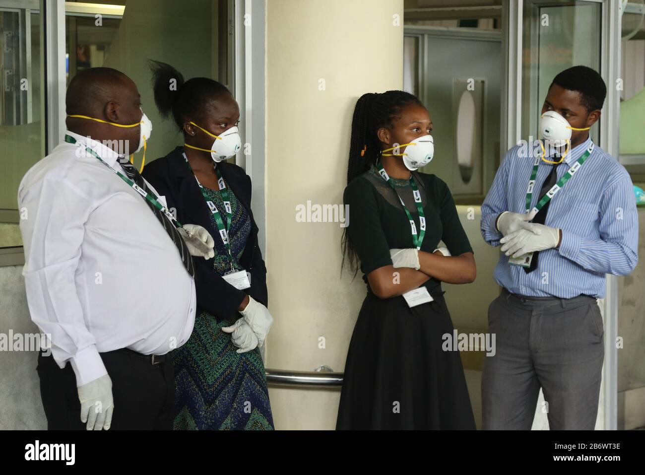 (200312) -- HARARE, March 12, 2020 (Xinhua) -- Staff wearing face masks work at the Robert Gabriel Mugabe International Airport in Harare, Zimbabwe, March 11, 2020. Zimbabwe's main airport is '60 percent prepared' to deal with COVID-19 and more resources are required for training and procurement of essential protective equipment for critical staff, Ruth Labode, chairperson of the parliamentary portfolio committee on health said Wednesday, after touring the Robert Gabriel Mugabe International Airport in Harare to assess its preparedness to deal with the virus. (Photo by Shaun Jusa/Xinhua) Stock Photo
