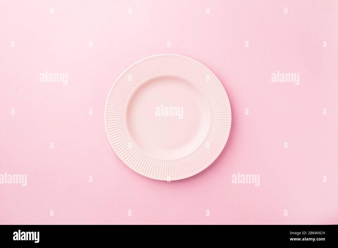Empty plate on pastel pink background. Flat lay copy space ...