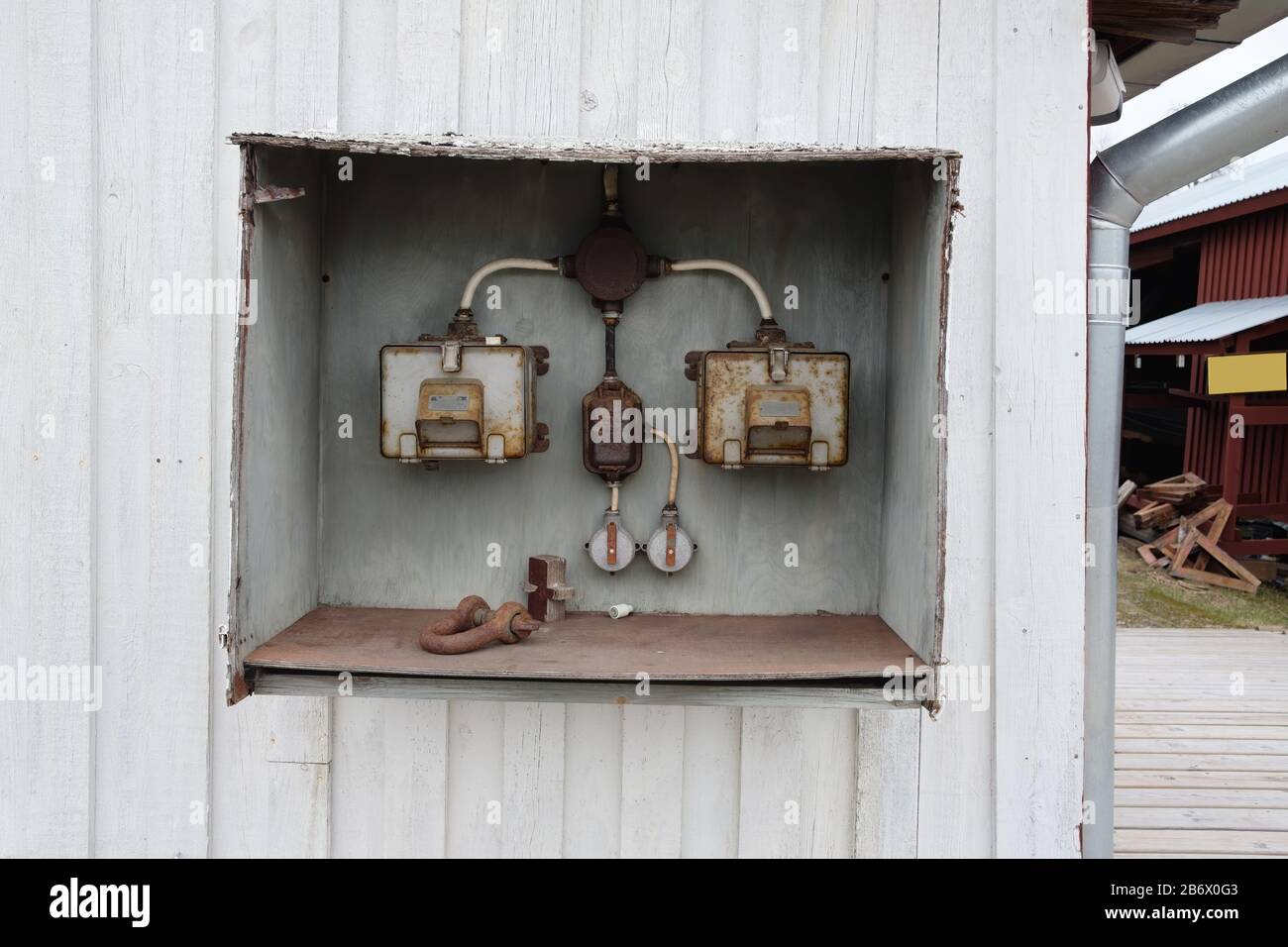 Old and rusty electric control box on the wall. Stock Photo