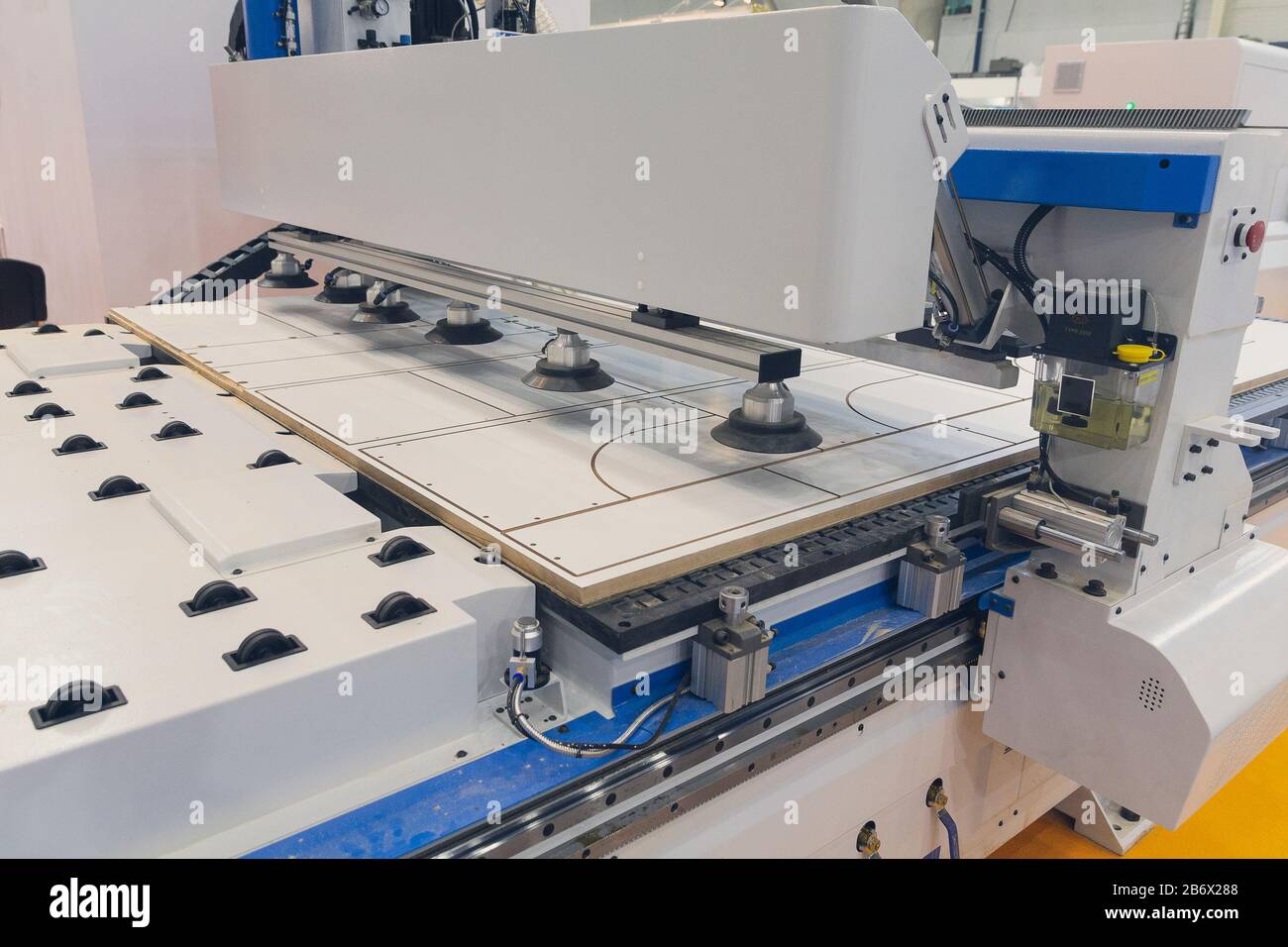 Machine tools format cutting are cut chipboard furniture in the shop. Industry Stock Photo