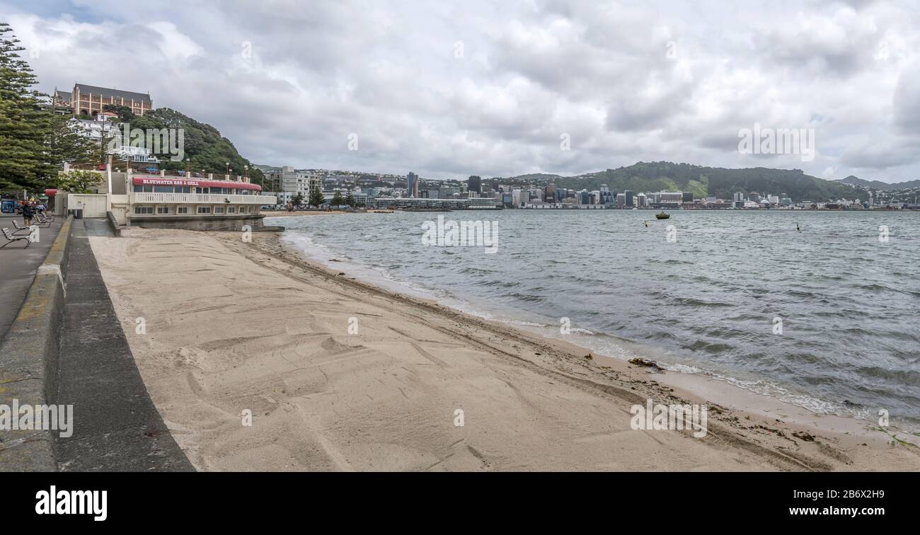 WELLINGTON, NEW ZEALAND - November 13 2019: cityscape with sand beach on bay shore at Oriental Parade neighborhood, shot in bright cloudy spring light Stock Photo