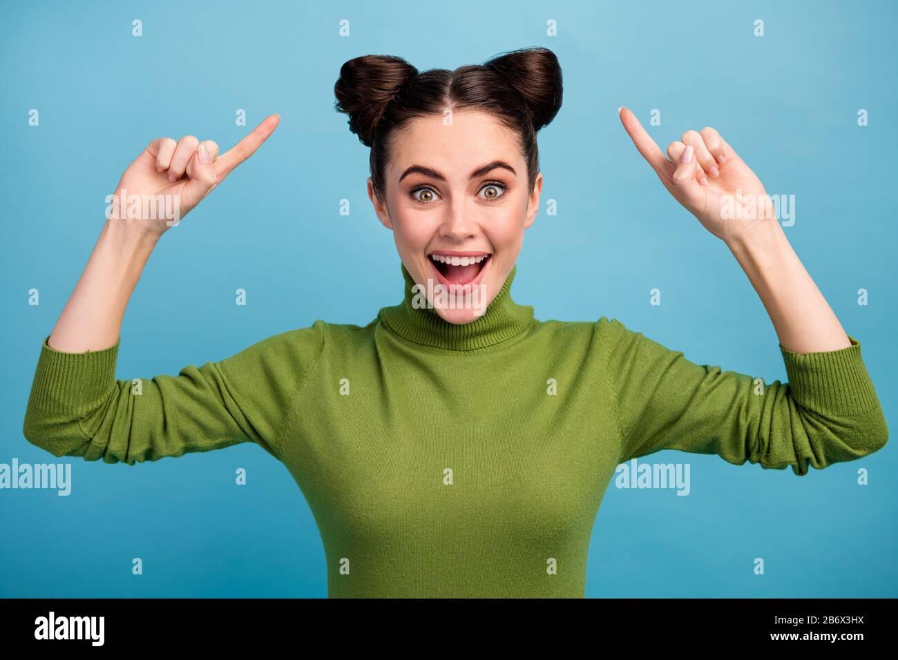 Photo of attractive amazed funny teen lady good mood indicating fingers hairdo advising cool hair stylist wear warm green turtleneck pullover isolated Stock Photo