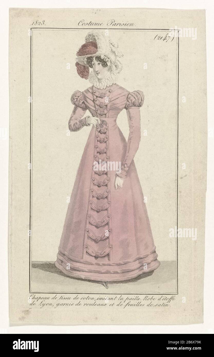 Journal des Dames et des Modes, Costumes Parisiens, 1823, (2147) Chapeau de  tissu de coton () Standing woman dressed in a gown of "étoffe de Lyon  'topped with a satin rouleaux and