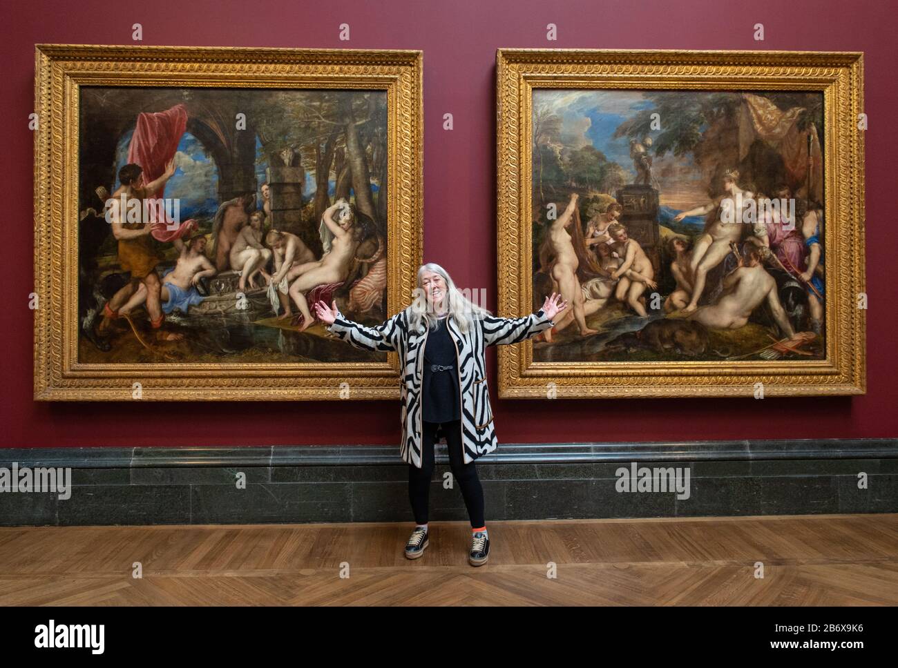 Historian Mary Beard views 'Diana and Actaeon' (left) and, 'Diana and Callisto', part of Titian's Poesie series of large scale Greek mythological paintings that feature in the 'Titian: Love, Desire, Death' exhibition, at the National Gallery, London. The exhibition brings the series of six paintings together in their entirety for the first time since the late 16th century. Stock Photo