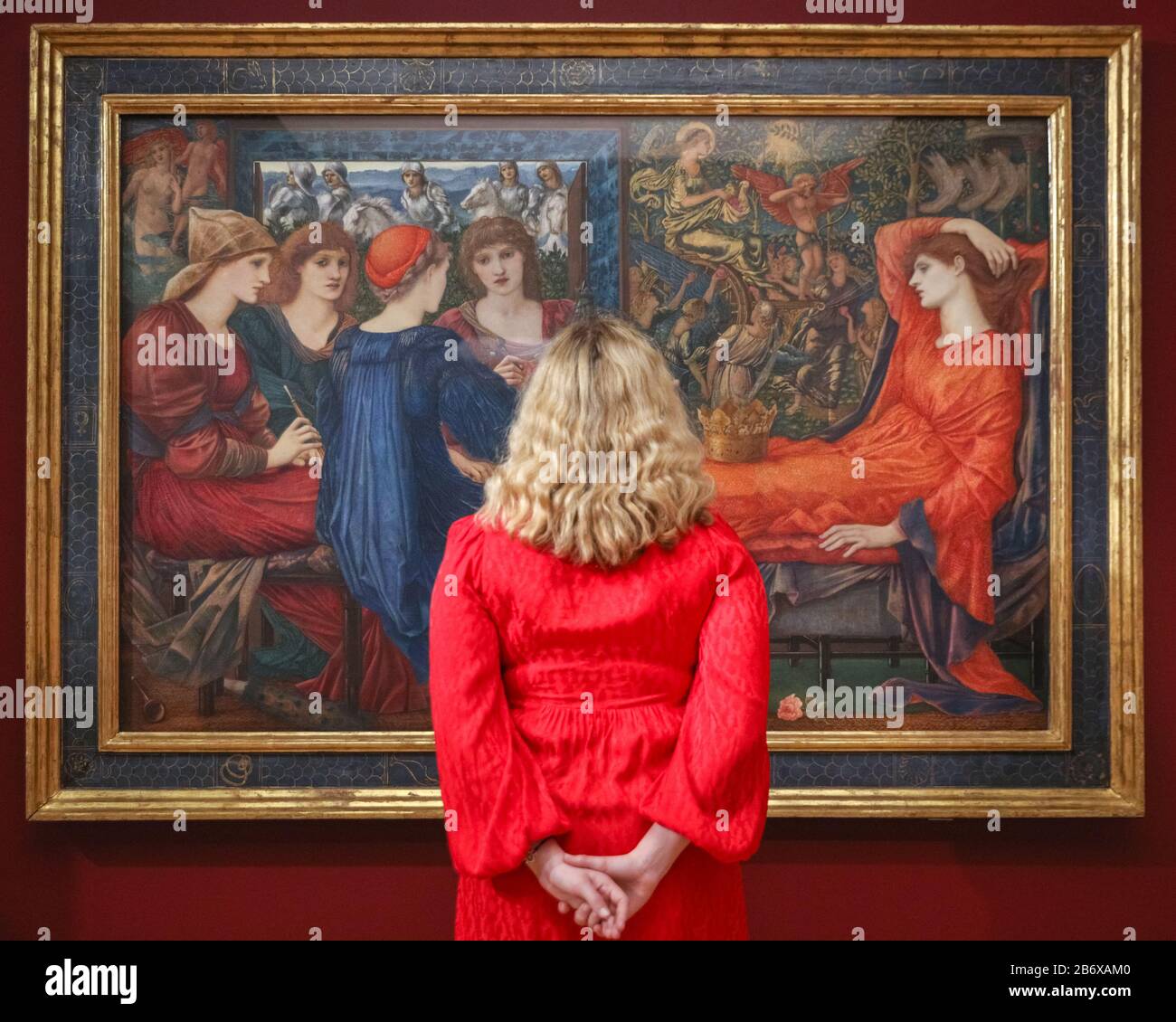 London, UK. 12th Mar, 2020. An assistant poses with Edward Burne-Jones' 'Laus Veneris', 1873-75. 'The Enchanted Interior', challenges the historic depiction of women in art with Pre-Raphaelite and contemporary female artists' works. The exhibition runs 13th March to 14th June, 2020. Credit: Imageplotter/Alamy Live News Stock Photo