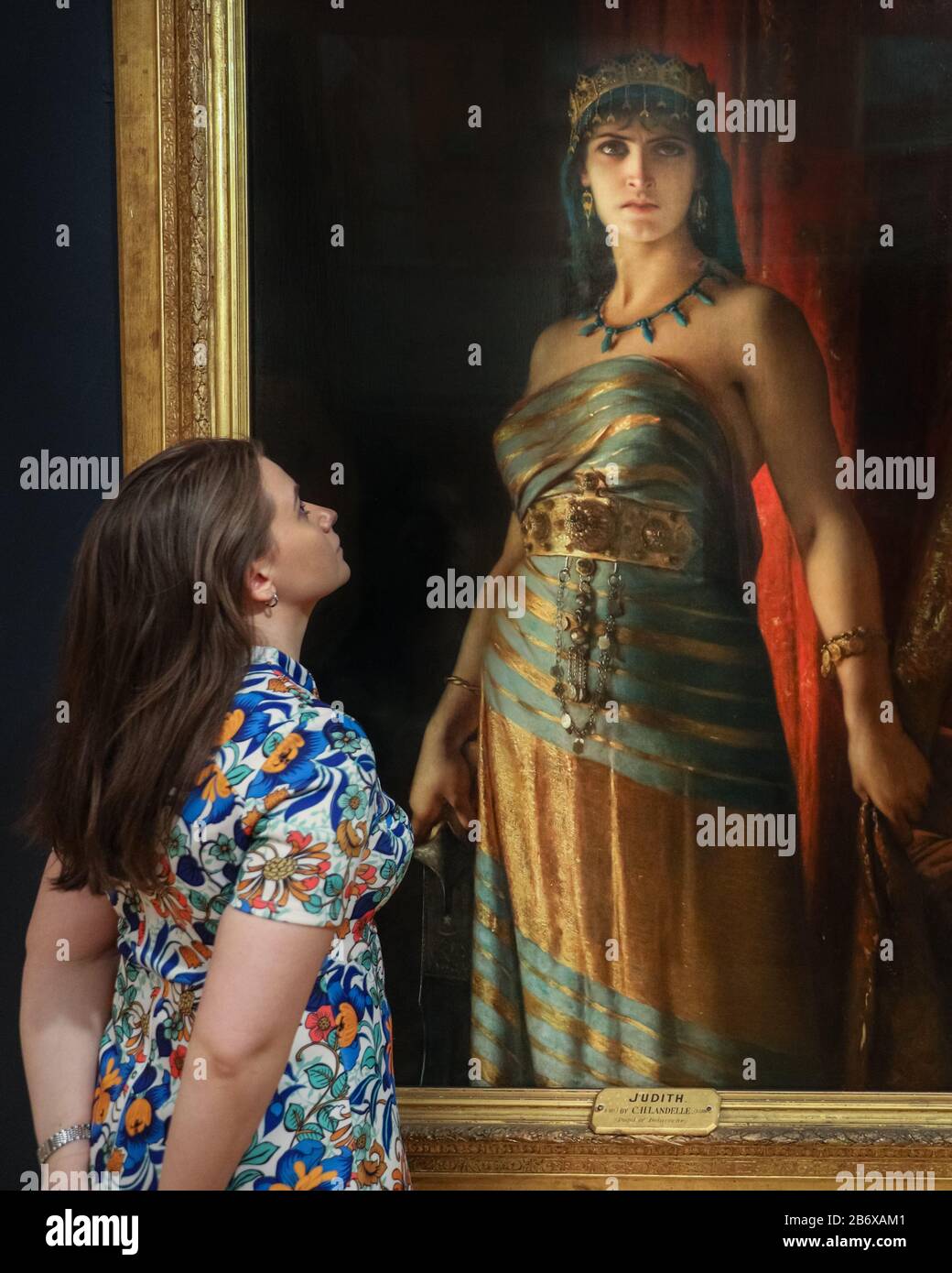 London, UK. 12th Mar, 2020. An assistant poses with Charles Landelle's 'Judith', 1887. 'The Enchanted Interior' at Guildhall Art Gallery, challenges the historic depiction of women in art with Pre-Raphaelite and contemporary female artists' works. The exhibition runs 13th March to 14th June, 2020. Credit: Imageplotter/Alamy Live News Stock Photo