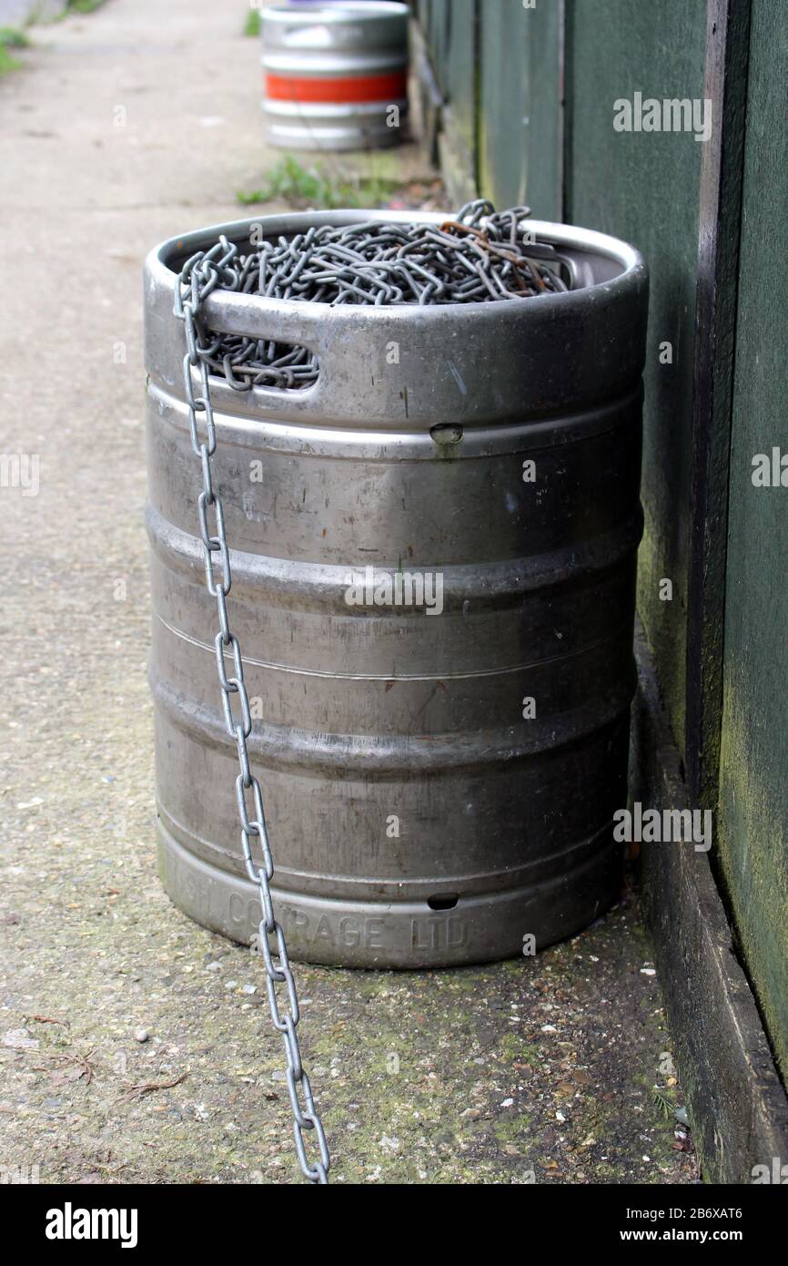Empty beer barrel and long chain by the wall of the old rugby club Stock Photo