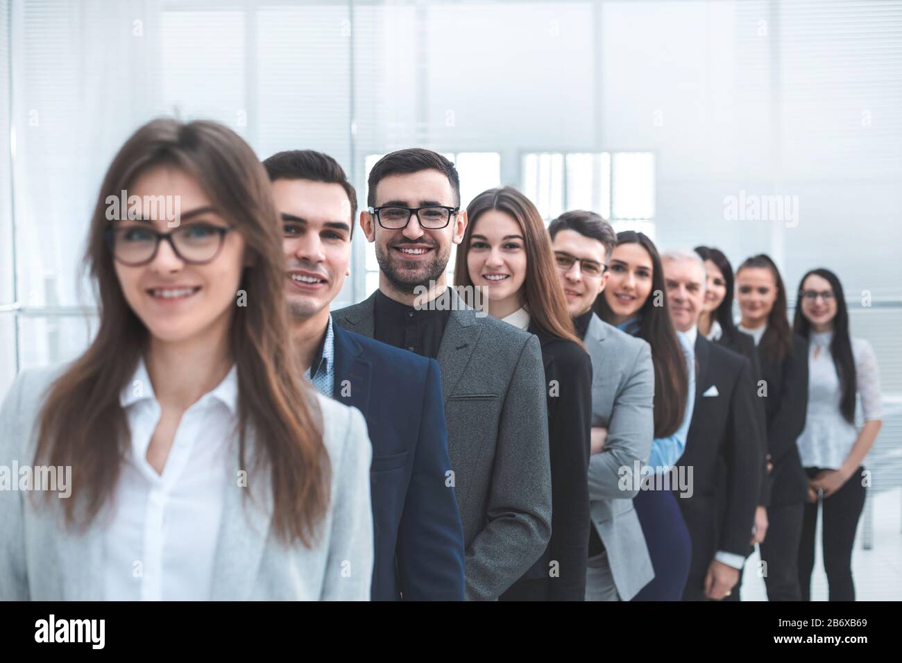 large group of young business people standing in a row Stock Photo - Alamy