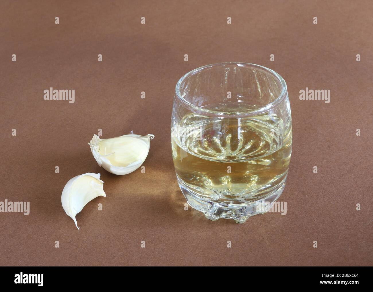 Garlic bulbs and garlic cloves with a glass of alcohol rakia Stock