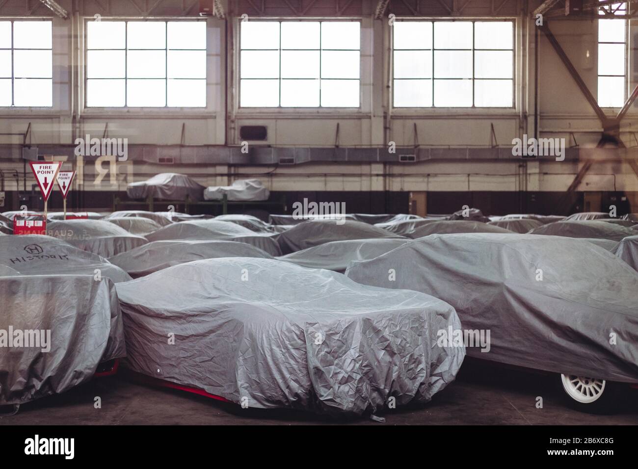 Lots of cars under cover in a hangar Stock Photo