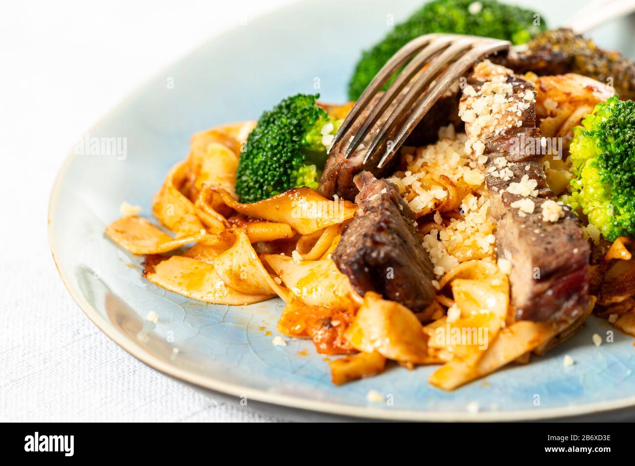 tagliatelli with steak slices on a plate Stock Photo