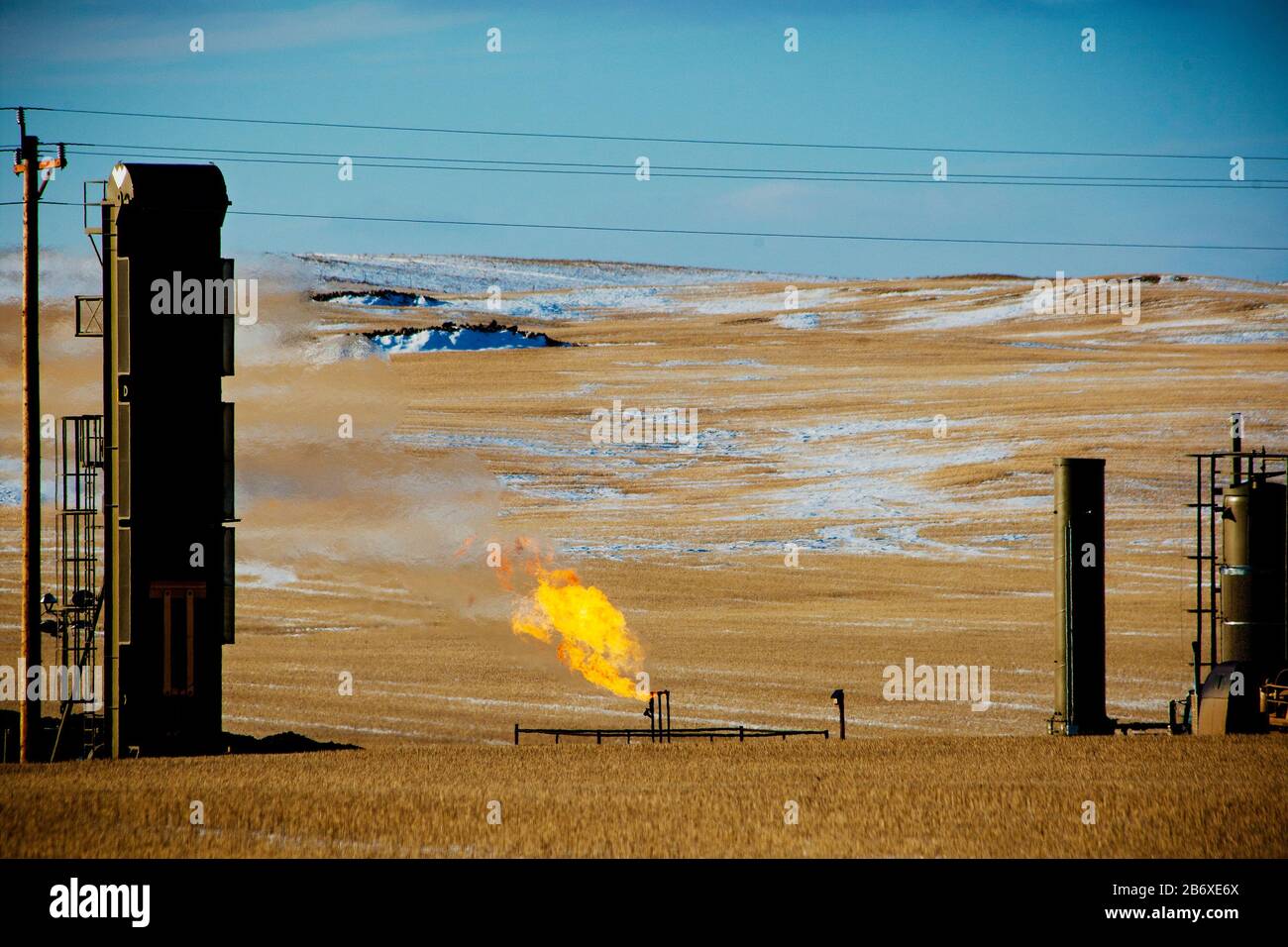 Flaring of gas from an oil well outside Williston in North Dakota. The area is part of the Bakken oil field, where fracking technology has made it profitable as long as the oil price stays above USD 46 per barrel. Stock Photo