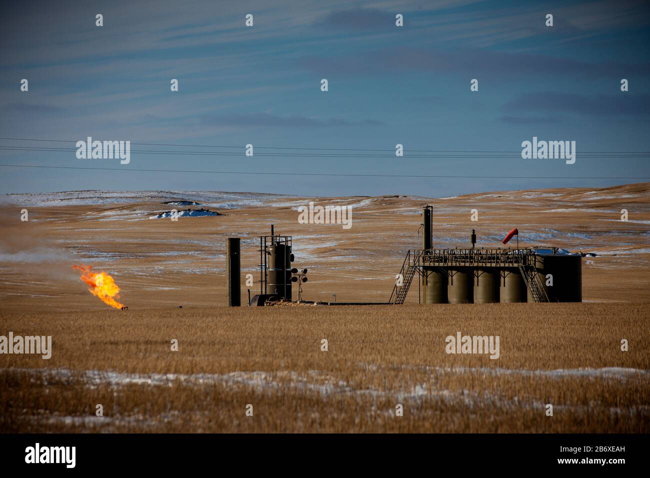 Flaring of gas from an oil well outside Williston in North Dakota. The area is part of the Bakken oil field, where fracking technology has made it profitable as long as the oil price stays above USD 46 per barrel. Stock Photo