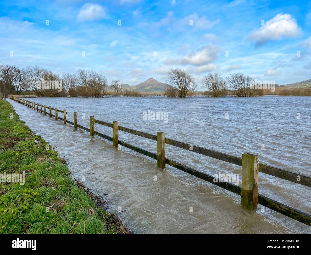 Wooden fence and farmland under water as a result of the River Severn bursting its banks after heavy rain Stock Photo
