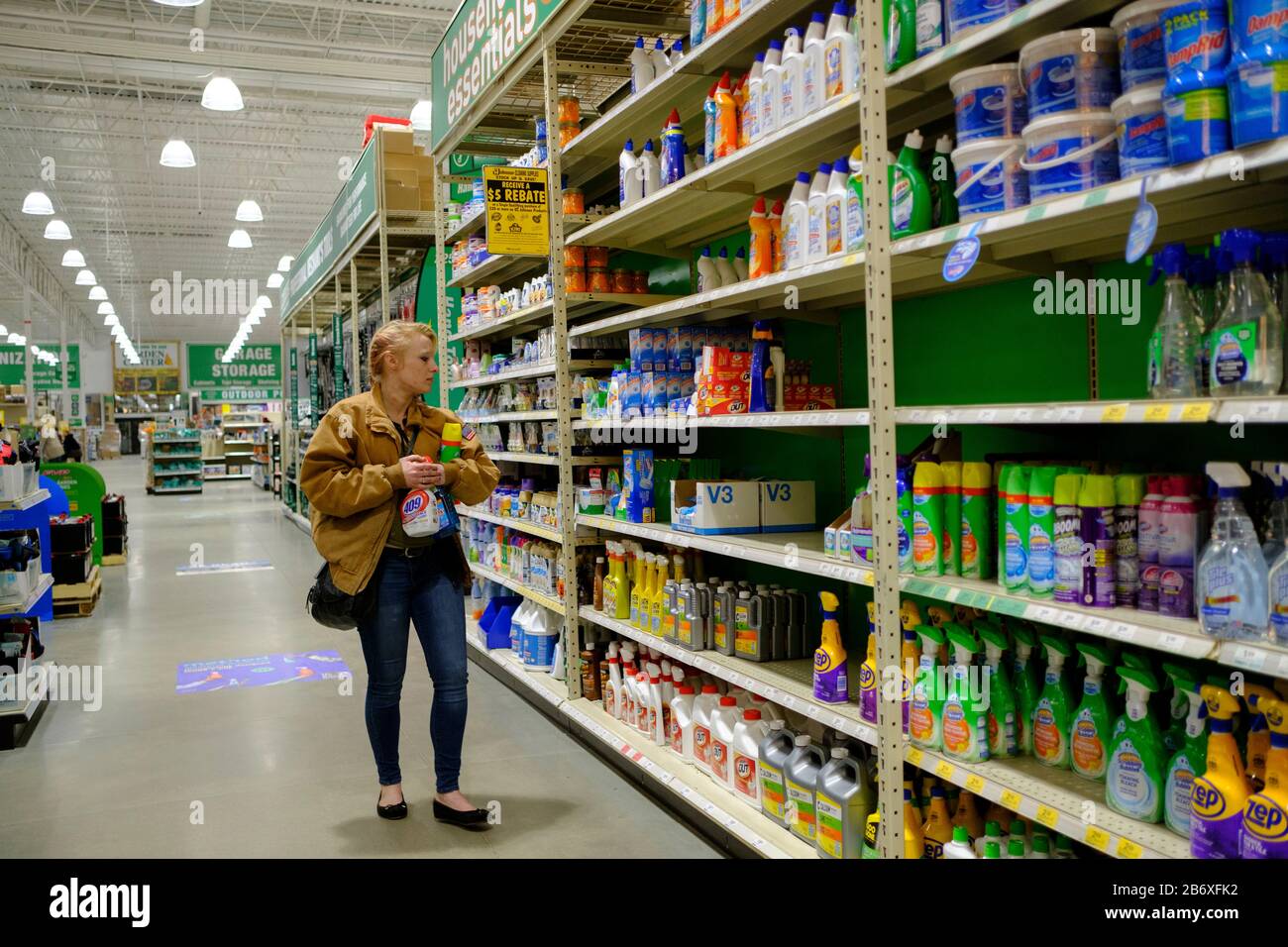A woman shopping for disinfectants at Menards on the day World Health Organization declared Coronavirus to be a pandemic.Toilet paper, wipes, protective breathing masks, and other items are either sold out at local stores, or are in short supply. Stock Photo