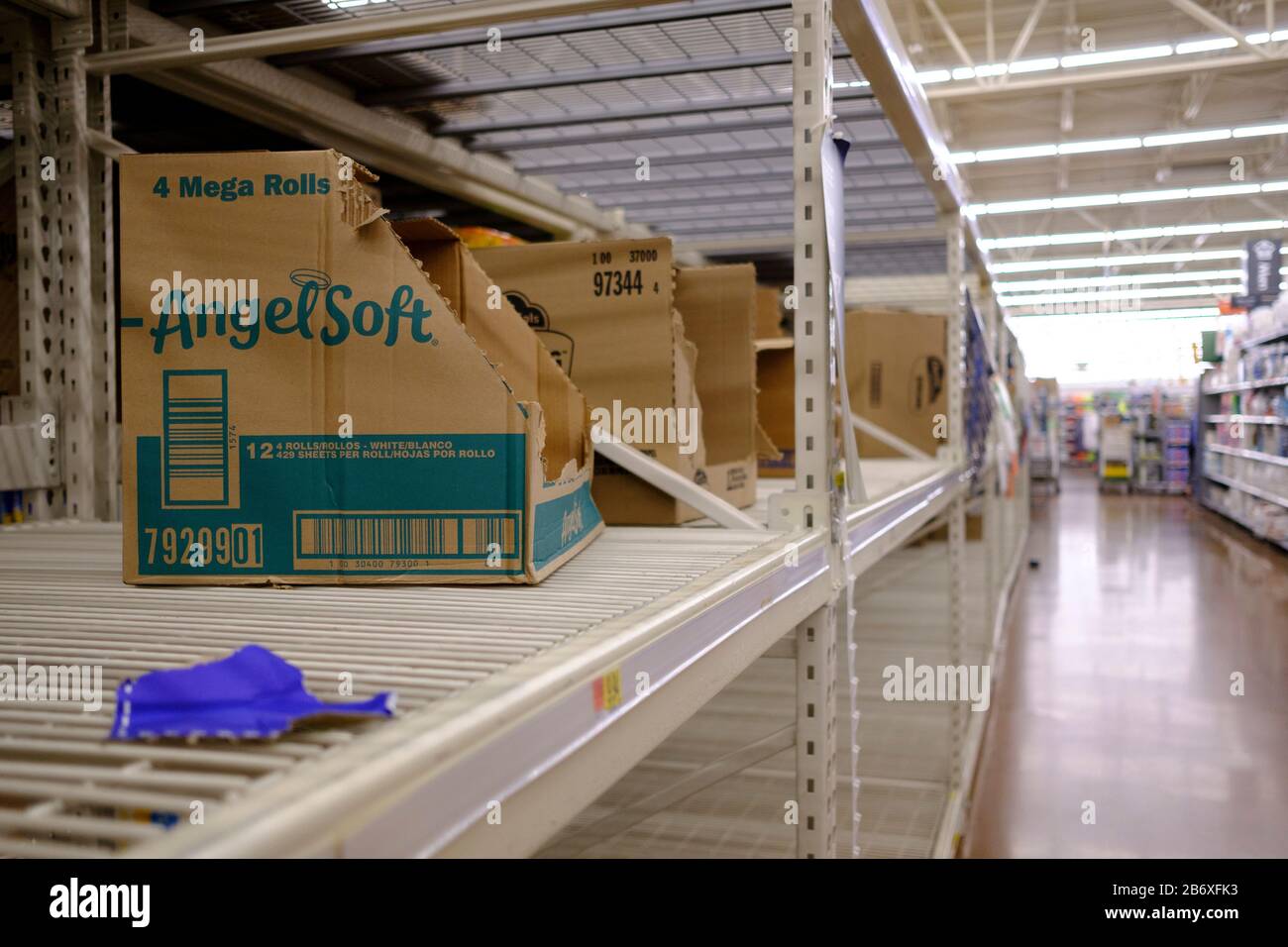 View of toilet paper shelves emptied by panic buyers at Menards on the day World Health Organization declared Coronavirus to be a pandemic.Toilet paper, wipes, protective breathing masks, and other items are either sold out at local stores, or are in short supply. Stock Photo