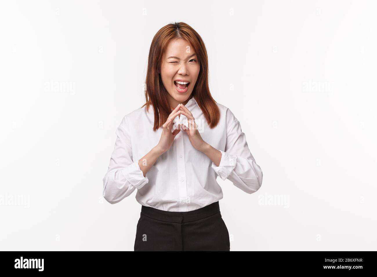 Portrait of smart and creative female asian manager, have evil plan, steeple fingers like genius and grimacing with pleased sly smile, scheming, have Stock Photo