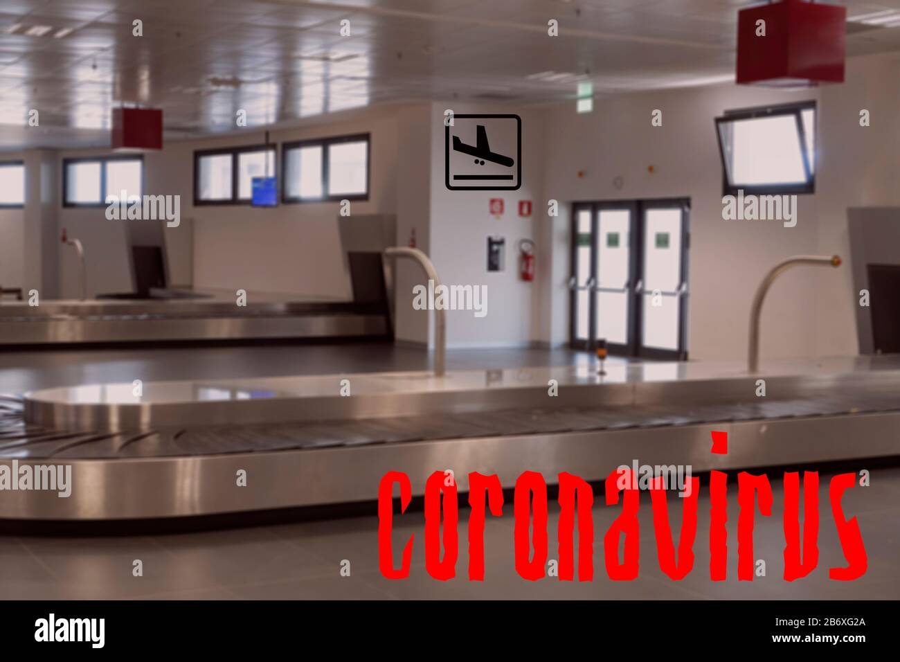 Airport empty luggage belt COVID-19 world outbreak no flight concept. No crowd at baggage carousel area, with coronavirus title. Stock Photo