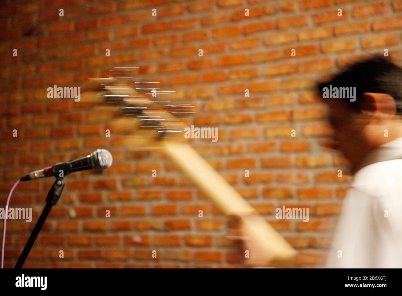 Playing electric guitar on stage. Blurred image. Stock Photo