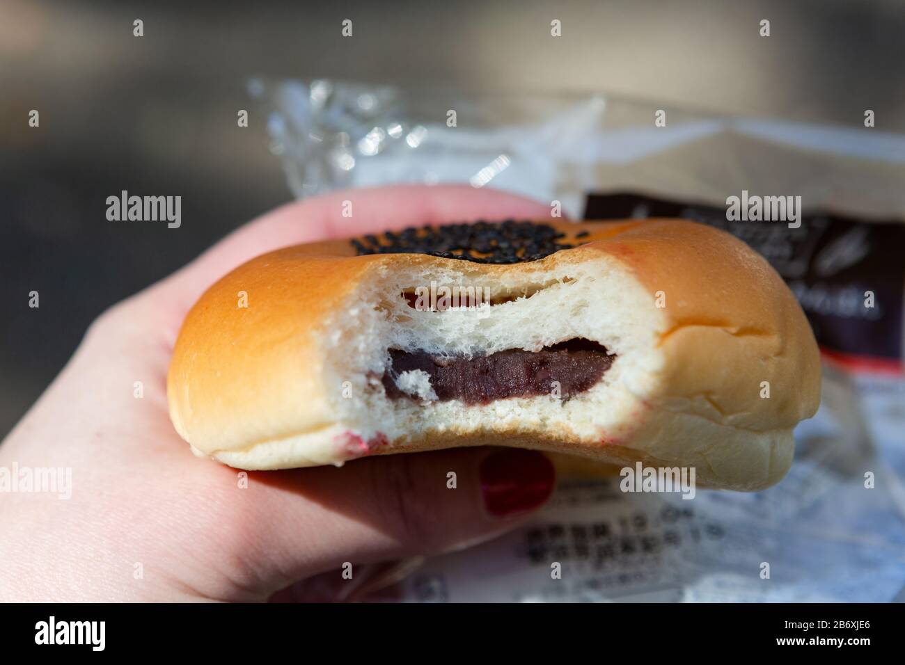Anpan, Japanese Red Bean Bun, with a bite taken to show the inside