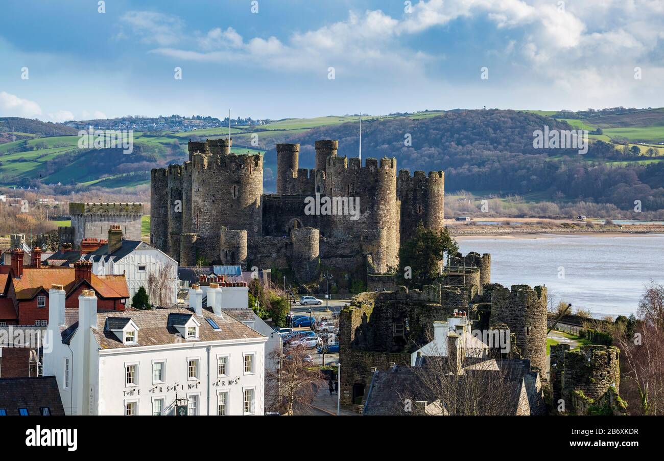 Conwy castle across the roof tops from the town wall fortifications, Wales Stock Photo