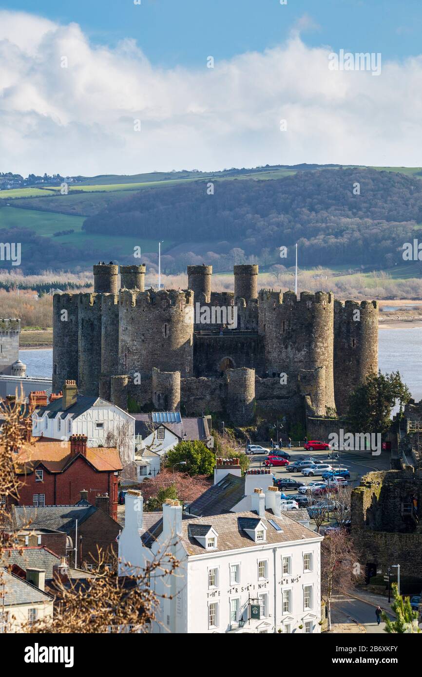 Conwy castle across the roof tops from the town wall fortifications, Wales Stock Photo